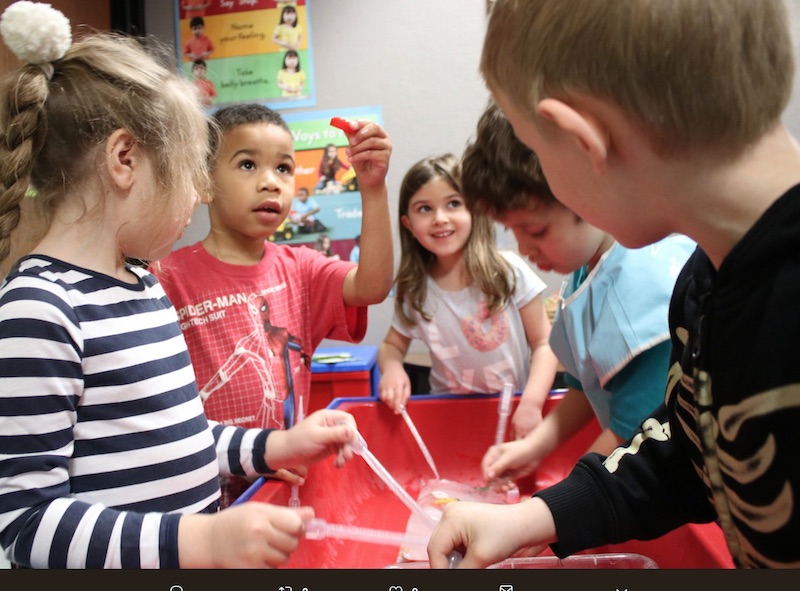 PreK students exploring a water table