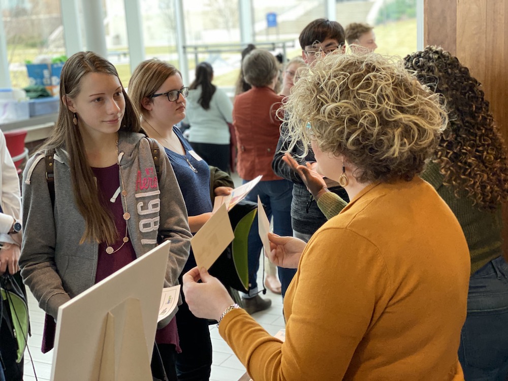 Female student talking to design professional