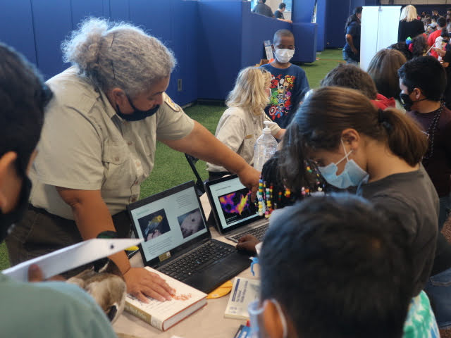 Wildlife Ranger show images on a laptop computer to group of students