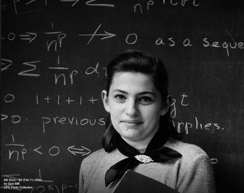 Woman in front of chalkboard with math equations