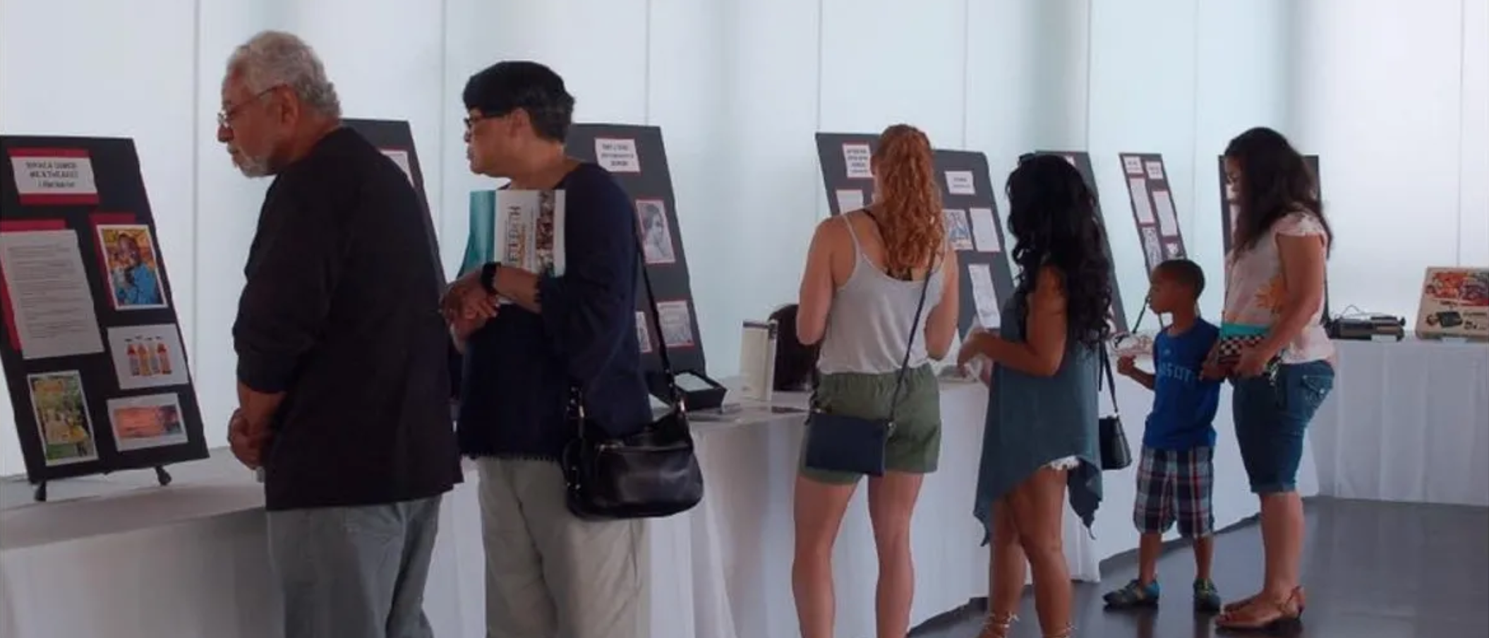Group of people looking at traveling exhibit